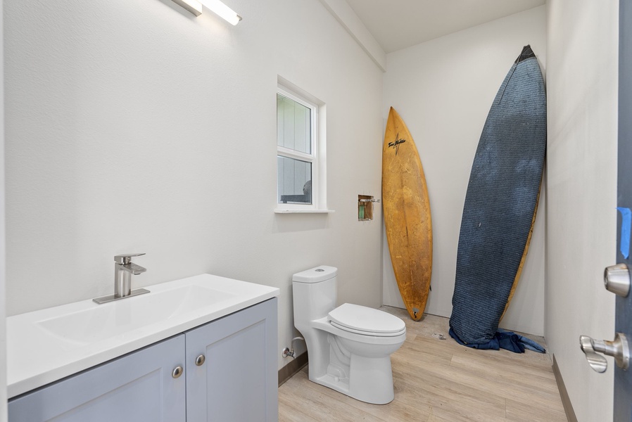 Second full bath with surf-inspired decor and updated finishes.