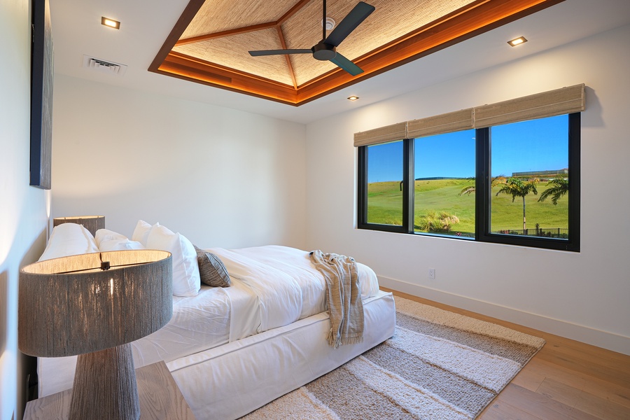 Guest suite with vaulted ceiling, ocean horizon views, and tranquil tones.