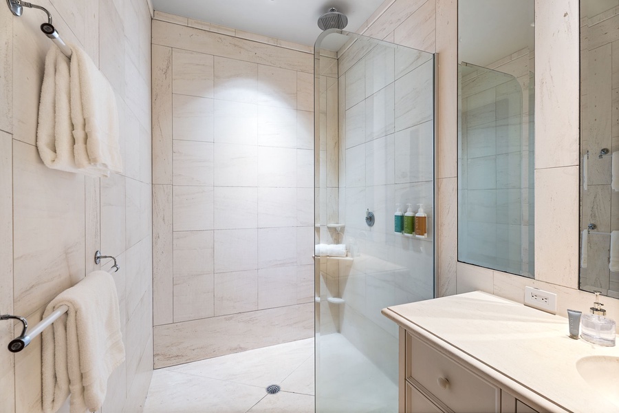 Step into your luxurious marble bathroom where rainfall shower and plush towels await your daily retreat.