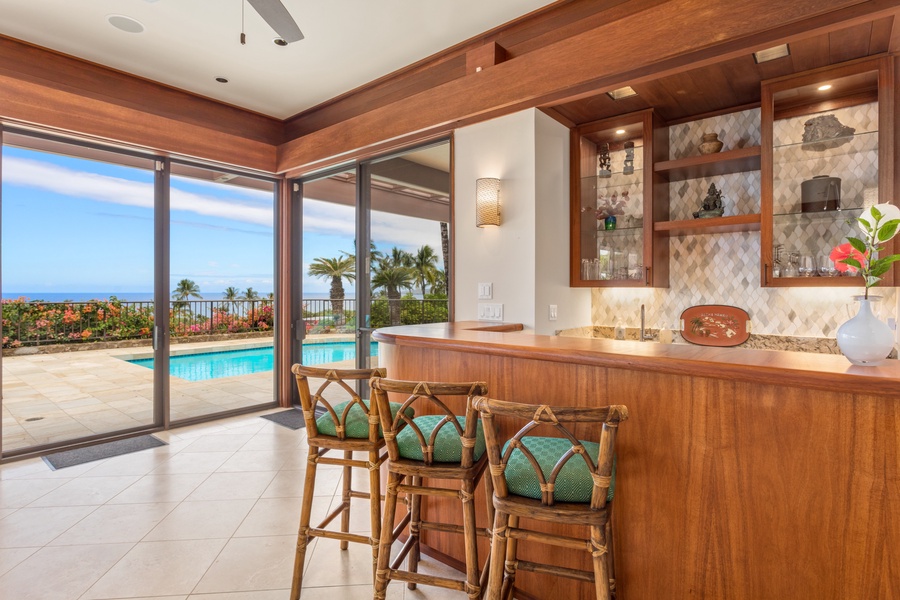 Mix it up Behind the Fabulous Wet Bar w/Hammered Pewter Sink, Drawer Fridge & Freezer, Glassware & Bar Accoutrements.