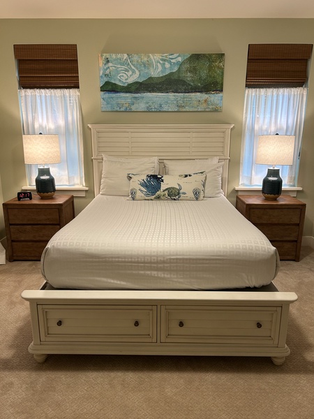 Guest bedroom with queen bed and soft coastal tones — a serene space for restful nights.