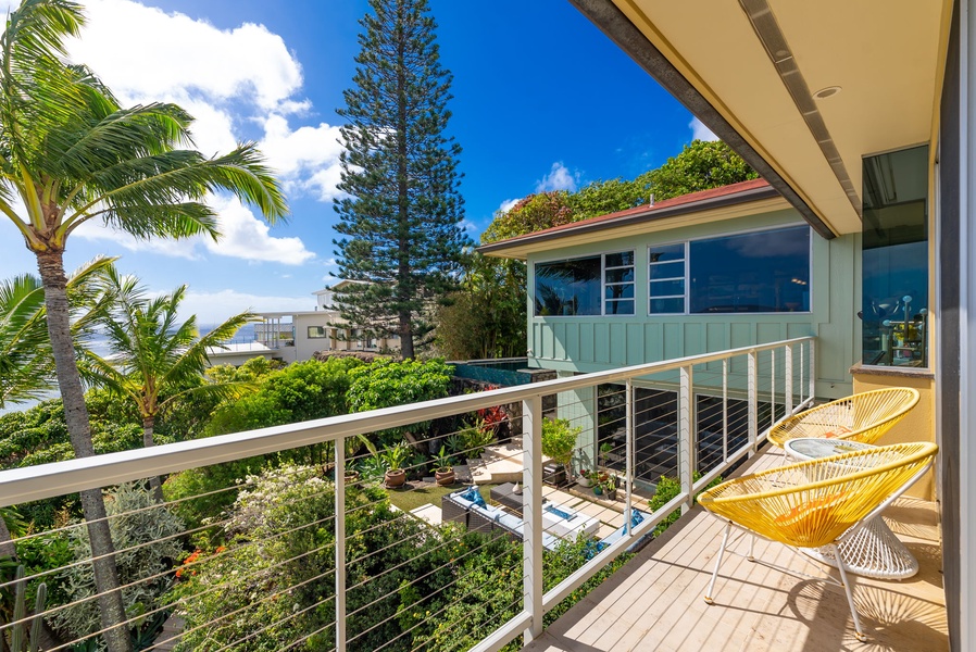 Private balcony with treetop and garden views offers a serene morning retreat.