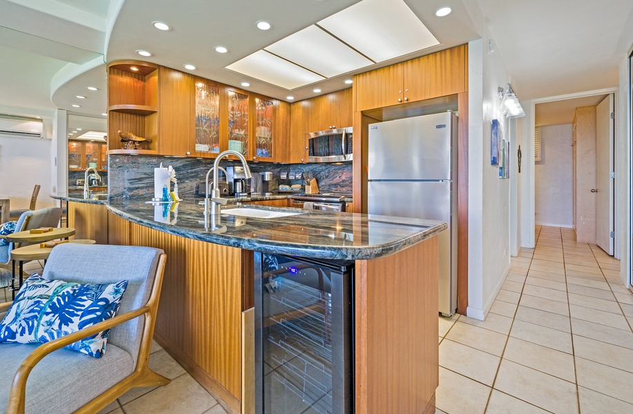 The spacious kitchen island provides extra counter space, complete with a wine cooler