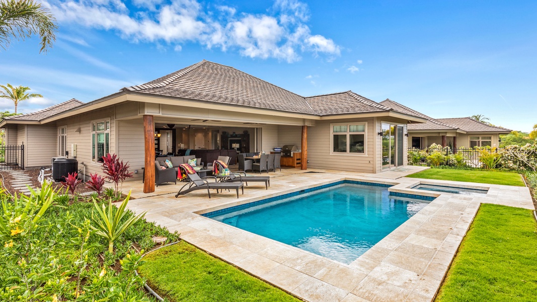 Wide angle view of pool, spa, garden, lanai, and exterior of the estate home.