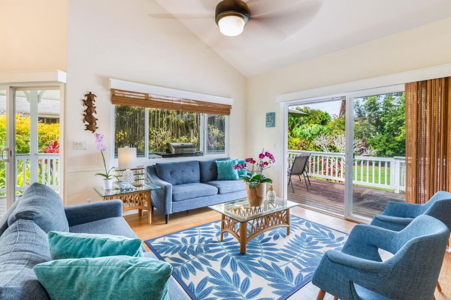 The bright and open living area features plush sofas, large windows and easy access to the lanai