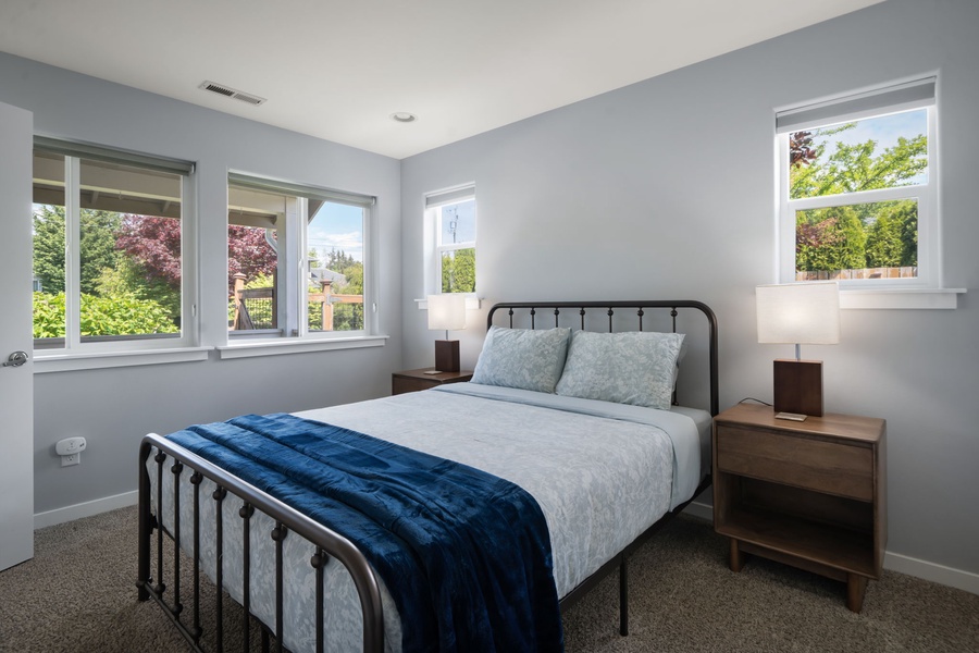 Large windows bring natural light into this inviting guest room designed for peaceful extended stays.