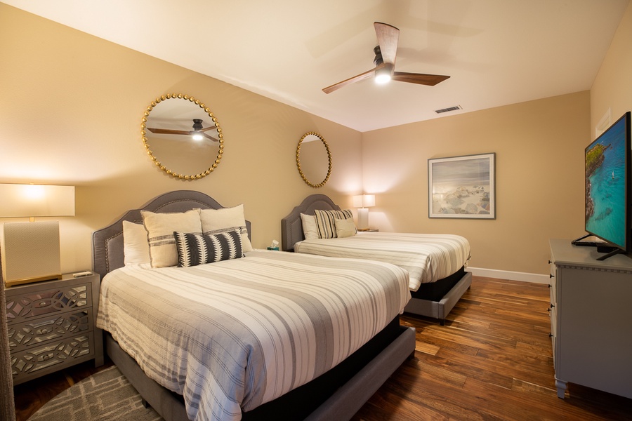 Fourth bedroom on the lower level has two queen beds, big screen TV, private lani and large walk-in closet to tuck clothes and luggage away for your stay.