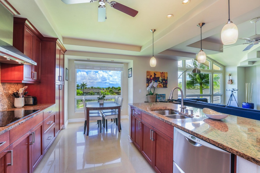 A roomy kitchen area with ample appliances and tools, dining table with four seats, and a view!