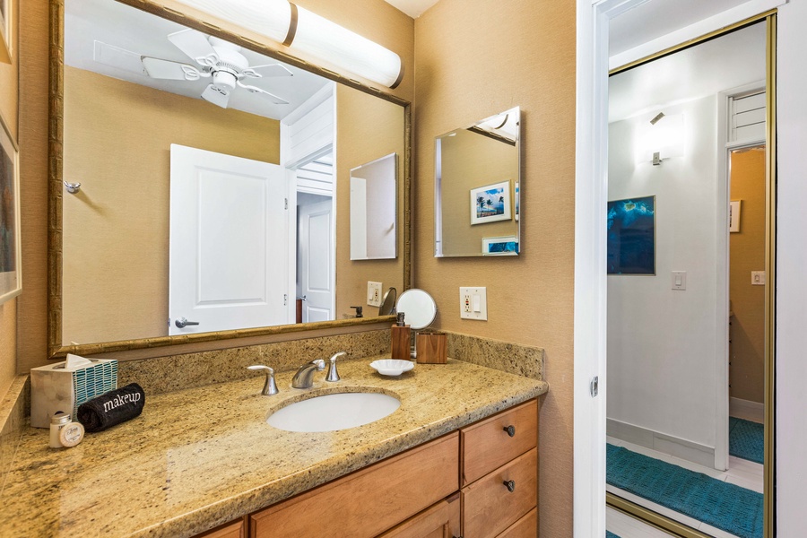 A well-lit vanity area with ample counter space, perfect for getting ready for the day or unwinding in the evening.