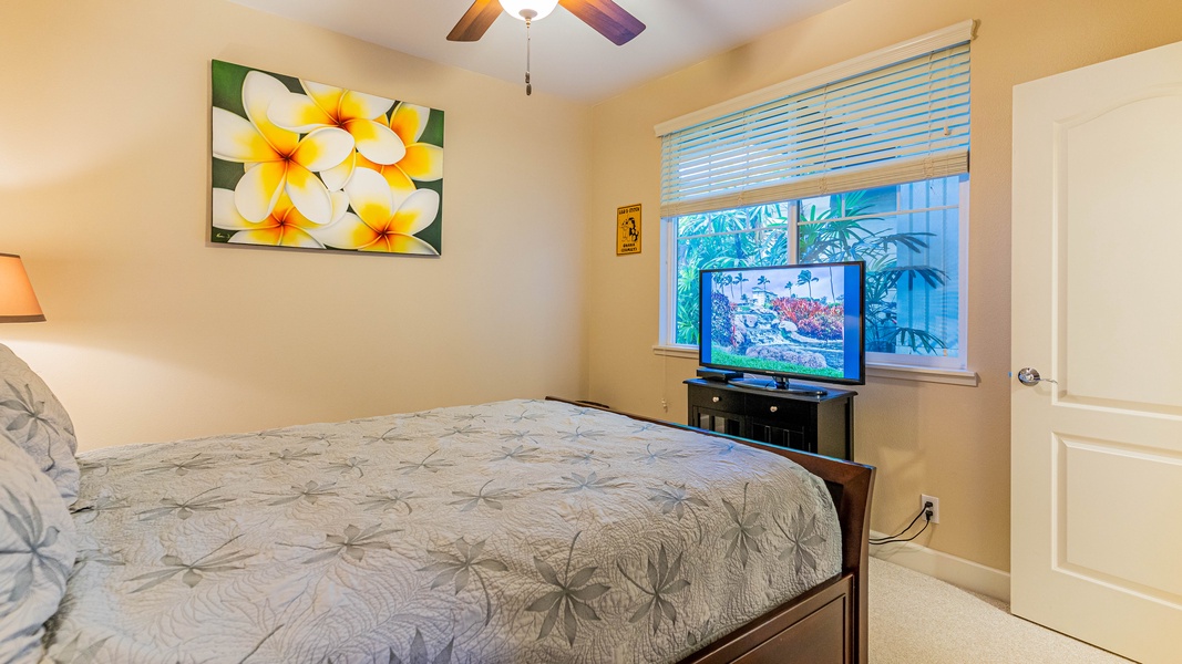 The downstairs bedroom offers a queen bed and TV.