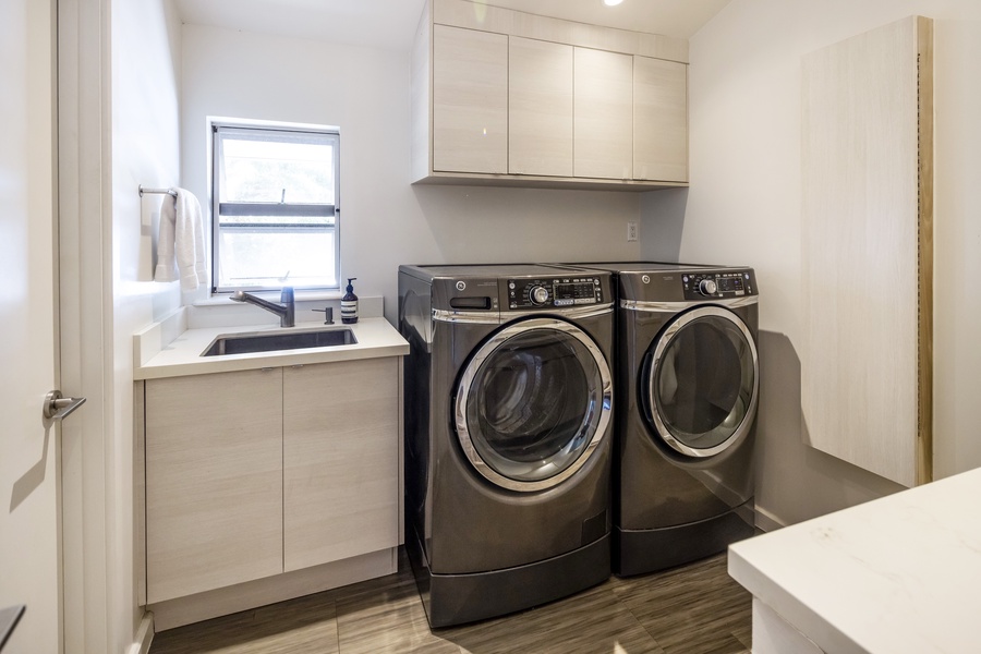 Fully equipped laundry room with washer, dryer, and ample space for daily essentials.