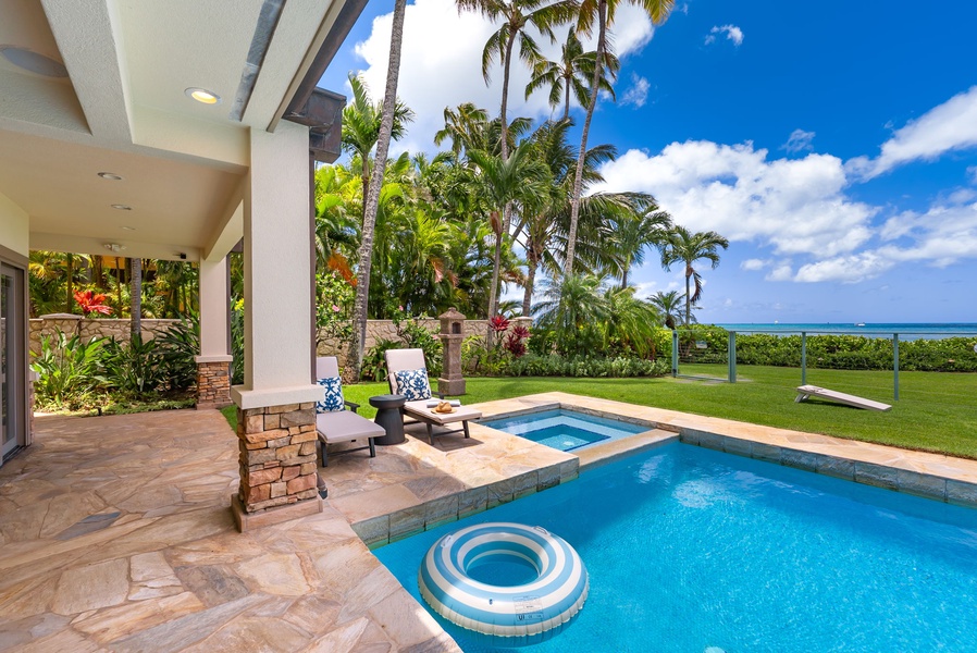 Relax beside the pool as tropical breezes and coastal views stretch beyond the palms.
