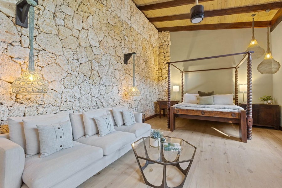 Cozy guest bedroom with a four-poster bed and a comfortable seating area.