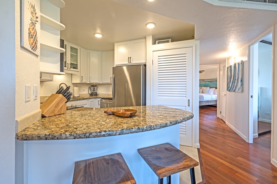 The kitchen's breakfast bar provides a cozy spot for a quick meal or morning coffee