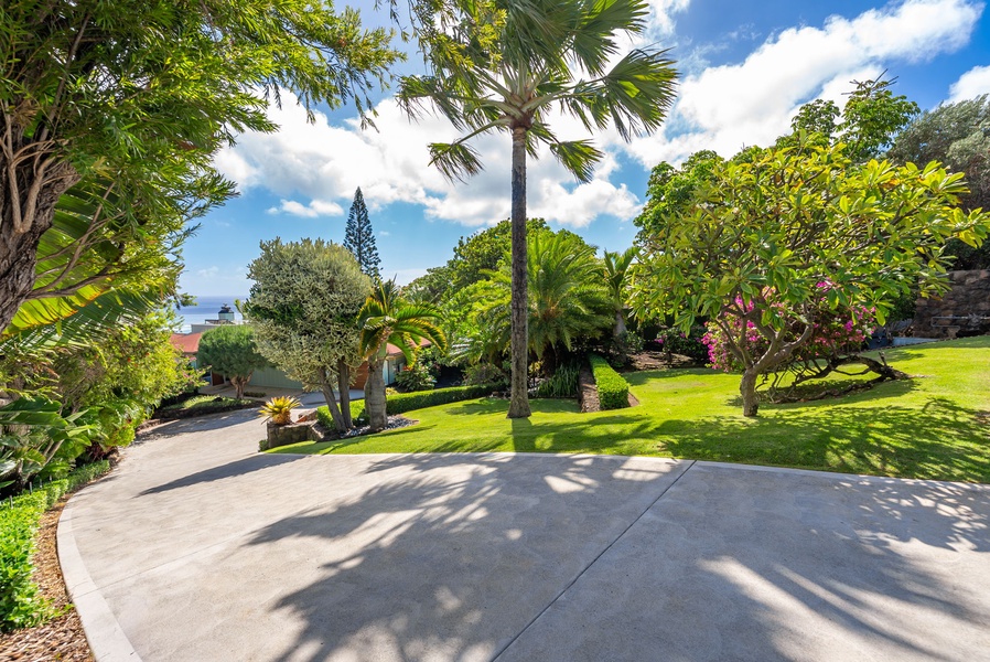 Manicured lawns and tropical trees create a tranquil setting near the entrance.
