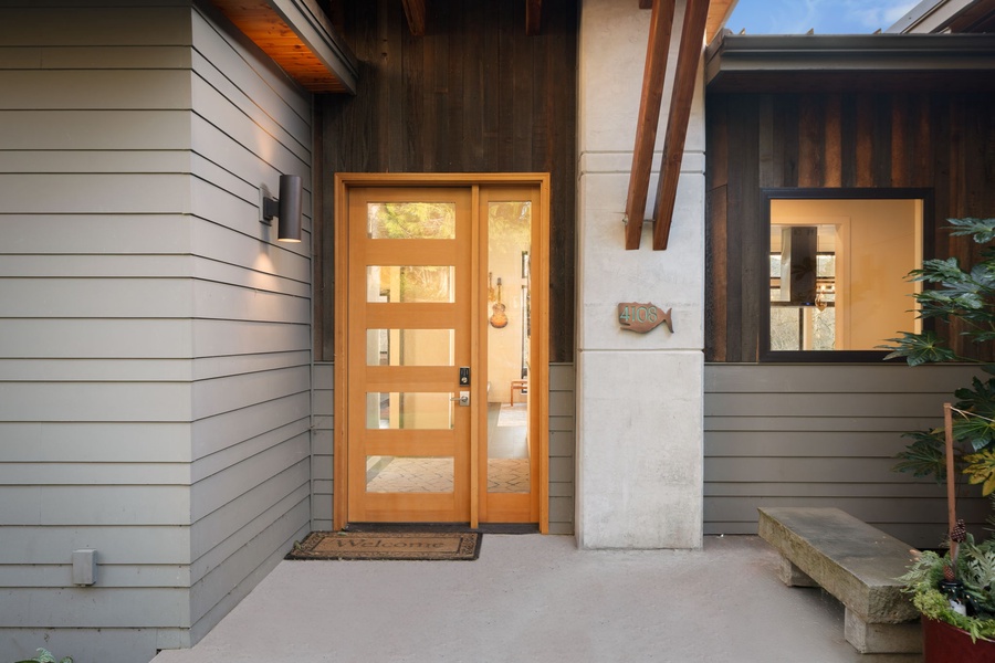 Modern architectural entrance with sleek materials and warm lighting creates an impressive arrival experience.