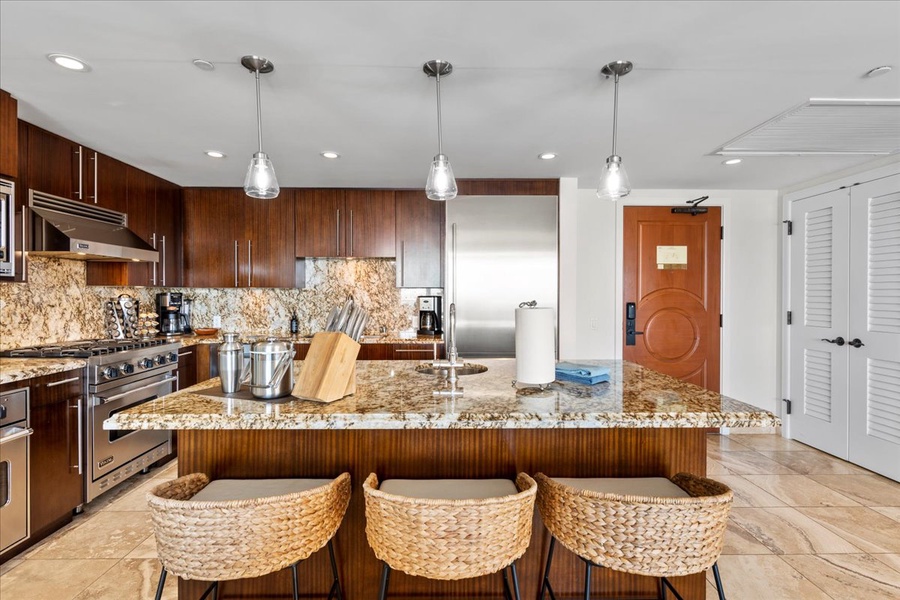 Modern kitchen island with comfortable seating and elegant lighting.