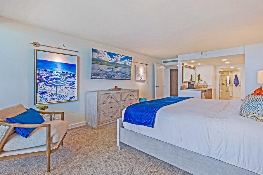 The primary bedroom features a king bed, flat-screen TV, and calming décor, providing a peaceful retreat.