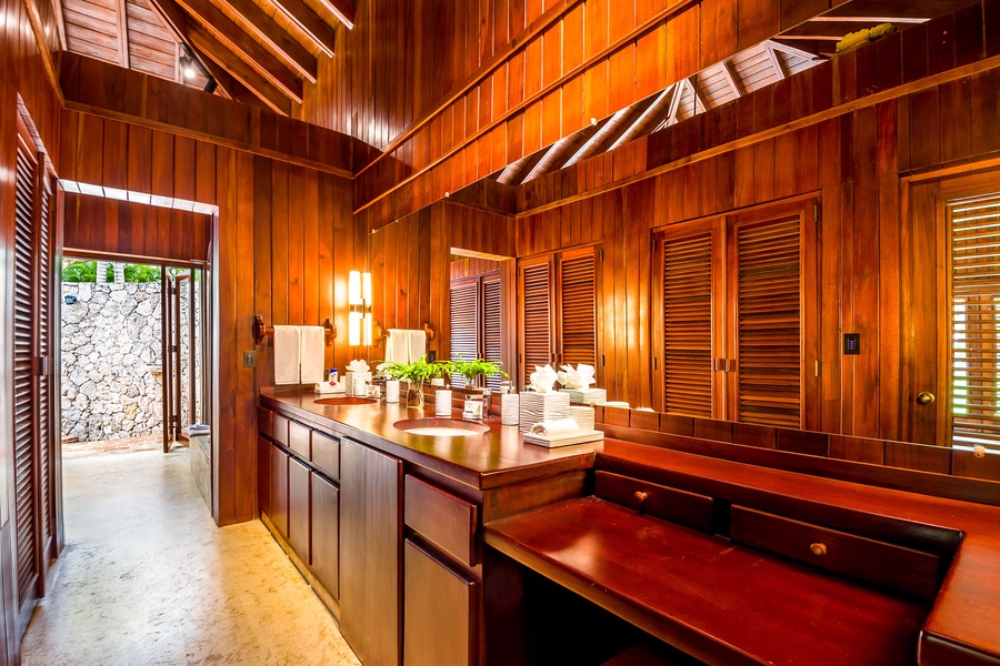 Luxurious full ensuite bathroom with wooden accents and ample lighting.