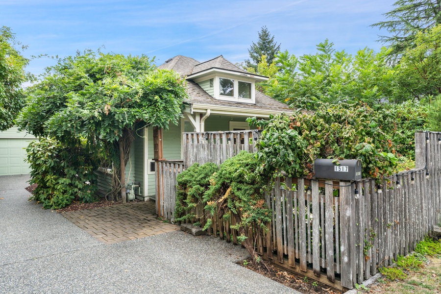 The home’s exterior blends seamlessly with its verdant surroundings, offering a tranquil and private escape.