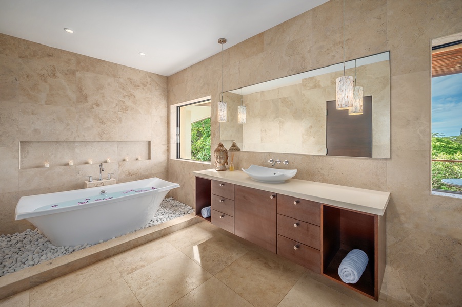 Spa-like bathroom featuring a spacious layout, dual sinks, and serene garden views.