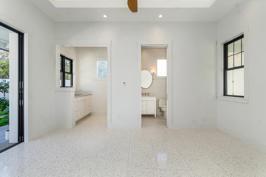 Expansive bath with dual access and abundant natural light.