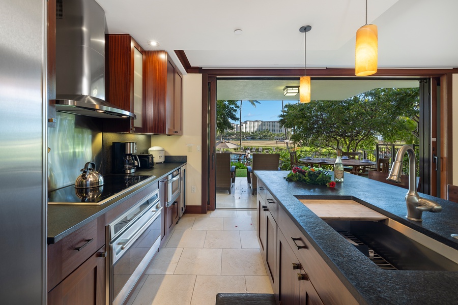 The kitchen features stainless steel appliances and lovely views.