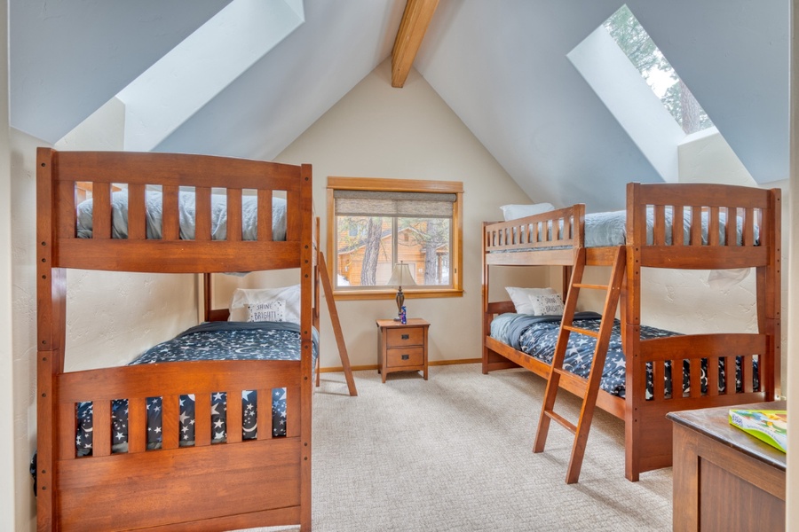 The guest bedroom with two twin-over-twin bunk beds equipped with a central AC, the perfect room for the kids