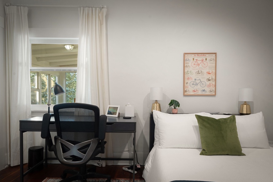 Settle into a restful bedroom with a sunny workspace and peaceful neighborhood charm.