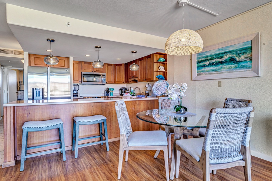 The open kitchen and dining area provide a welcoming space to enjoy meals with family or friends.