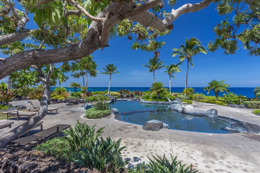 View of just a portion of the oceanfront multi-tiered lagoon style saltwater pool with plentiful loungers.