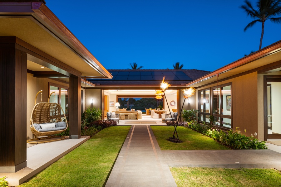 Illuminated courtyard design with manicured lawns under an evening sky.
