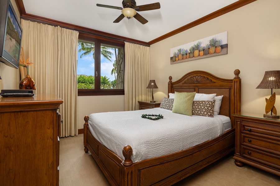 The second guest bedroom with a comfortable queen bed and TV.