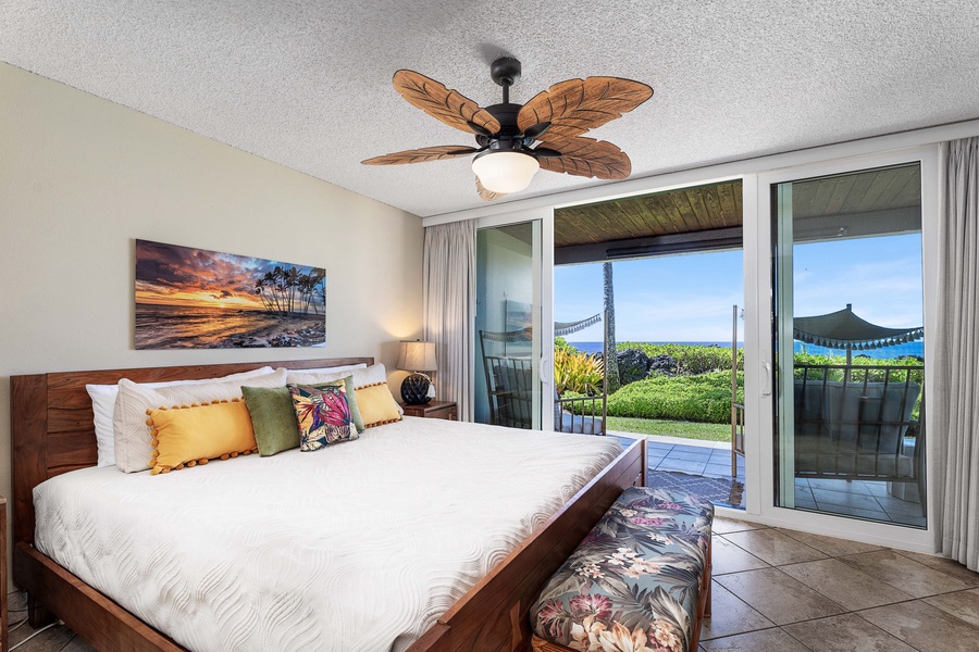 Plush king bed for the primary suite with access to the lanai.