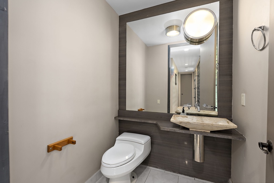 A modern half-bath with stylish accents and a sleek vanity.