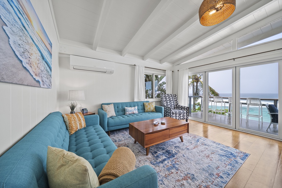 Bright and breezy main living area with vaulted ceilings, ocean views, and comfy seating for unwinding after a day on the North Shore.