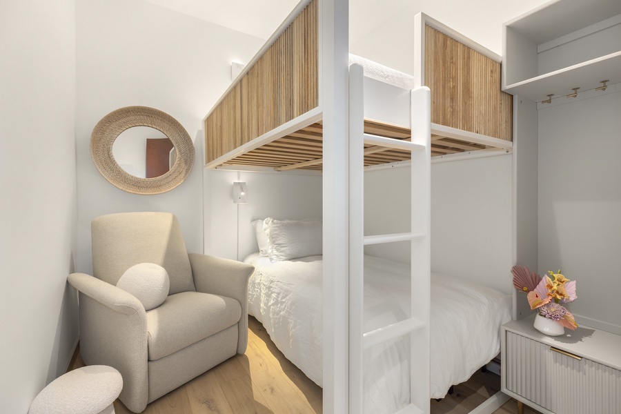 Guest bedroom 3 featuring a bunk bed and cozy lounge area, perfect for kids or additional guests.