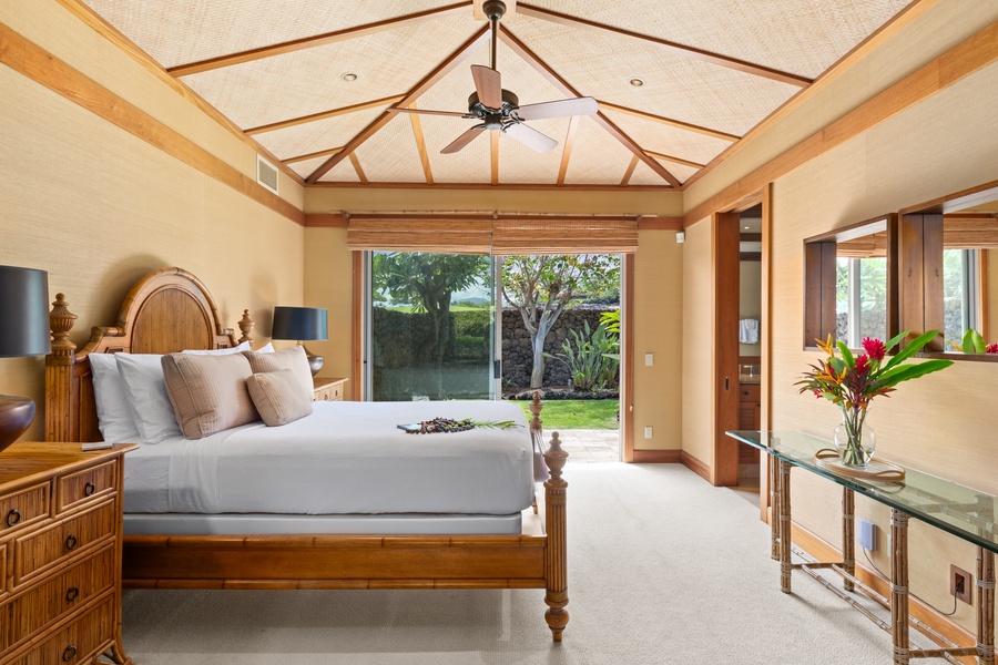 Second bedroom with private lanai access, en-suite bath, and vaulted ceiling—comfort with tropical charm.