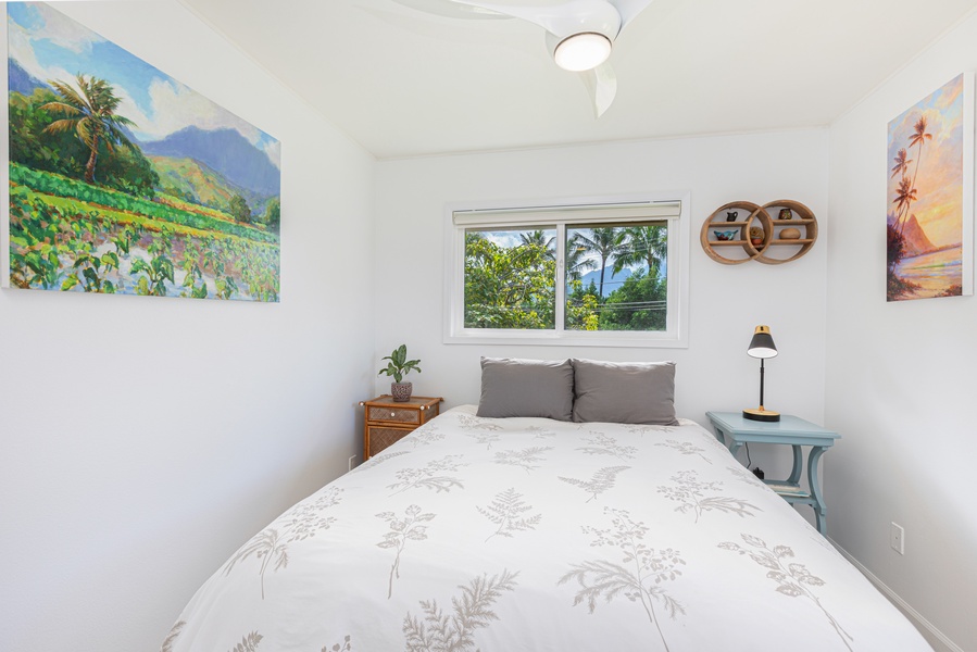 Peaceful corner bedroom with queen bed, Central A/C, ceiling fan for restful nights.