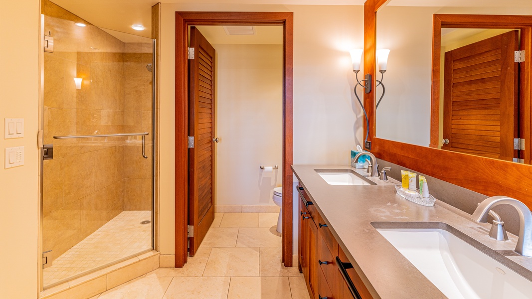 The primary guest bathroom with a walk-in shower and double vanity.
