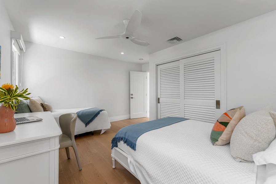 Neutral tones and thoughtful design make this bedroom a quiet place to recharge, with generous storage and cool comfort.