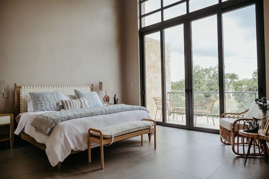 Rest in the light-filled guest bedroom with private patio.