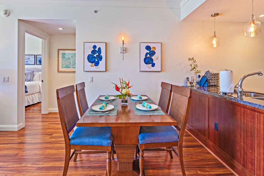 Cozy dining at Honua Kai Konea 206 with wooden table and seating for four.