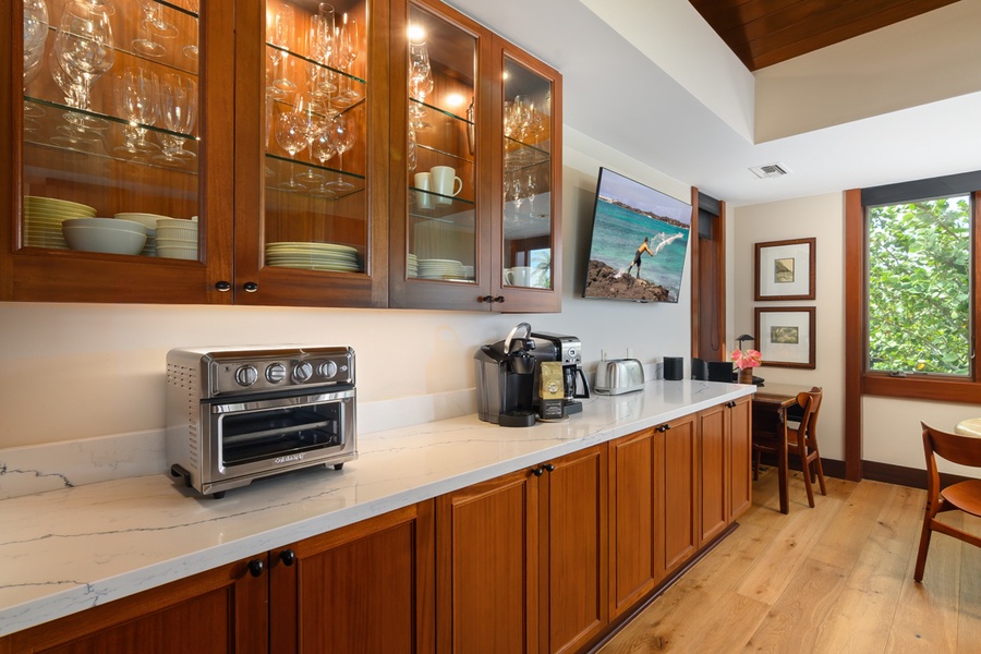 Your elegant kitchen features rich wood cabinetry, marble countertops, and top-tier appliances, creating a sophisticated space for preparing memorable meals.