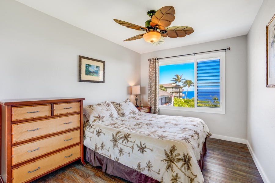 The second bedroom, equally inviting, features a queen bed, ensuring a restful night's sleep.