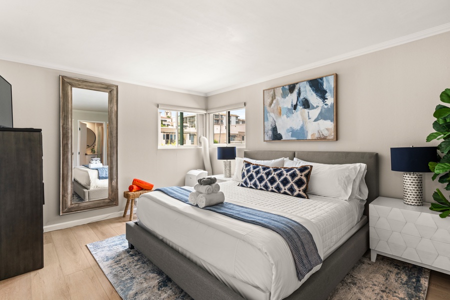 Spacious and serene bedroom with plush bedding, perfect for restful nights.