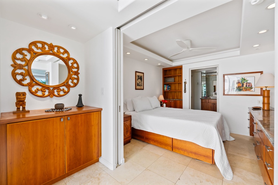 Stylish bedroom with warm wood furnishings and ample storage—experience both comfort and functionality in this beautifully appointed space.