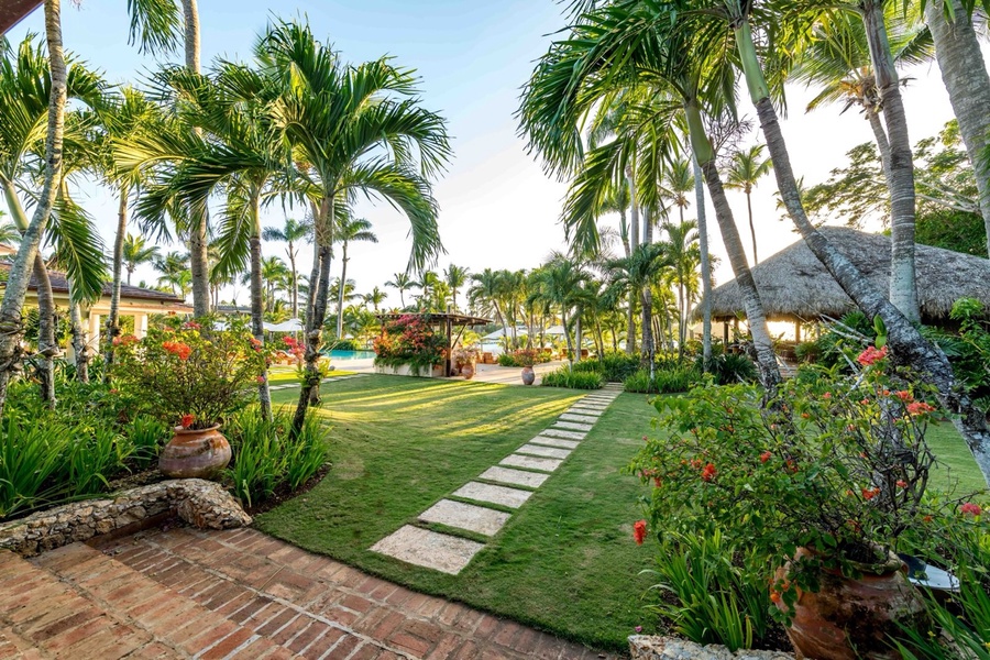Walkway leading through the vibrant gardens and pool area.