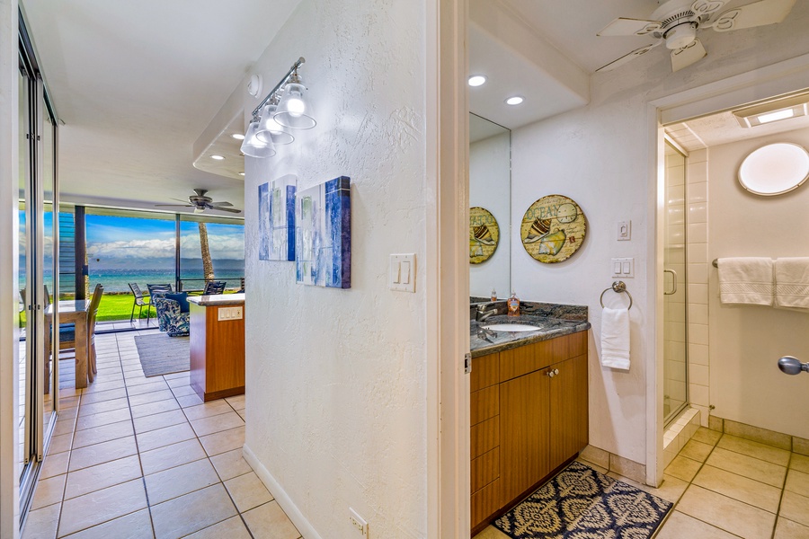 This hallway bathroom, conveniently located near the living space, features a contemporary vanity and stylish decor