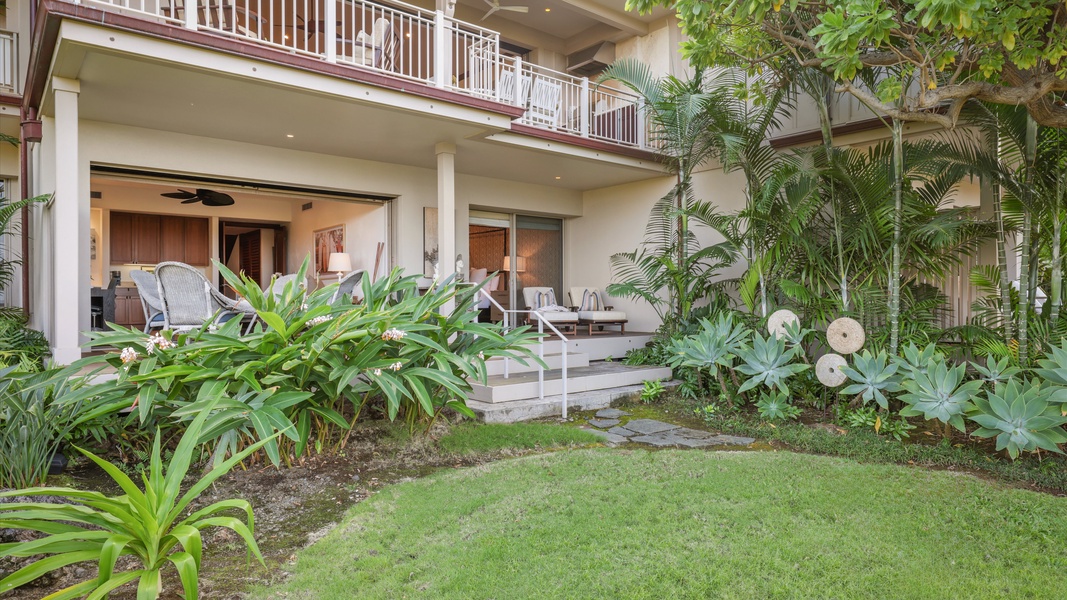 Private lanai overlooks a tranquil garden and manicured lawn.